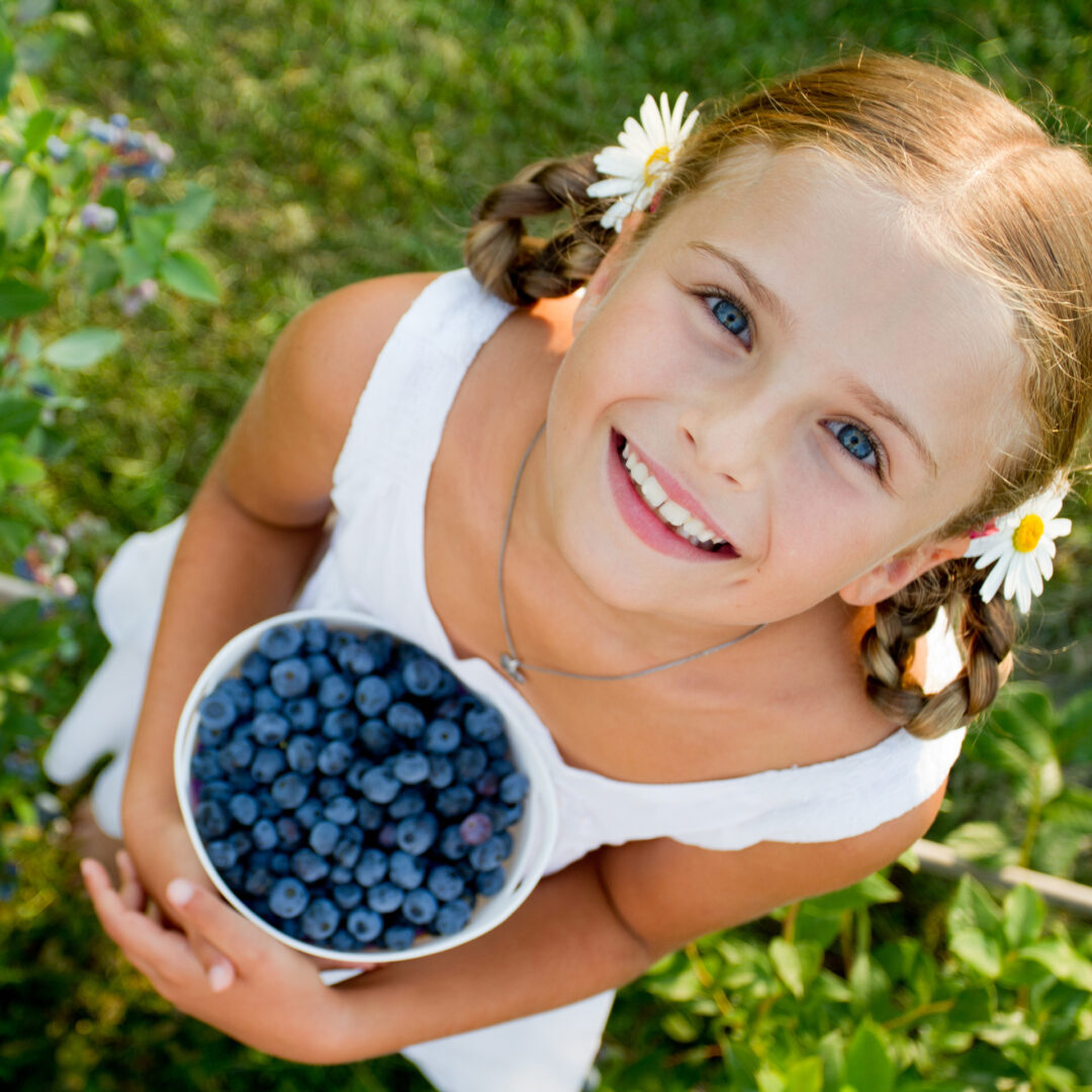 Girl with Blueberries Looking Up (1)